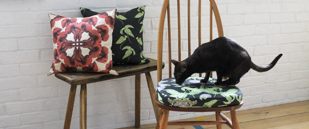 Ercol seat pad in Dryopteris Dark Fern Grey on denim, with Cotton Twill cushions, in Viva Magenta Mandala on Creme and Simple Fern Dark